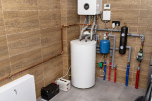 Home modern gas boiler room lined with ceramic tiles imitating wood, visible emergency power supply with a 12 volt battery.